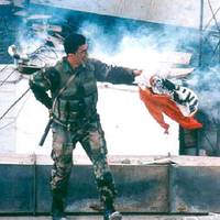 Special Forces commando burns an MRTA flag during Operation Chavín de Huantar