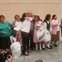 A group of women unjustly accused of terrorism thank Belgian priest Hubert Lanssiers after being freed
