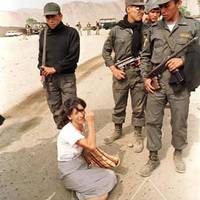 A woman weeps outside Castro Castro prison