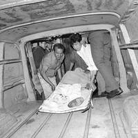One of the victims of the Barrios Altos massacre is transported to the Lima Morgue.